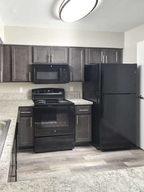 Black appliances in the kitchen at Hickory Point Townhomes in Newport News, Virginia