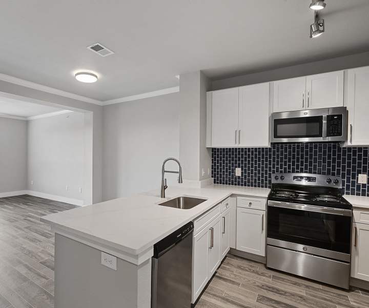 Kitchen with quartz countertops and stainless-steel appliances at Beacon Lakes in Dickinson, Texas