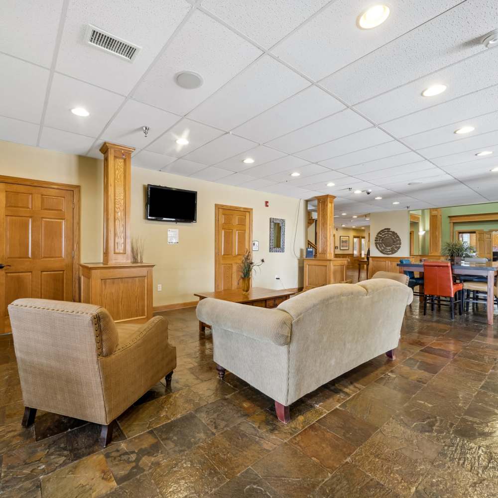 Clubhouse seating area with mounted TV at Windscape Apartments in Hobbs, New Mexico