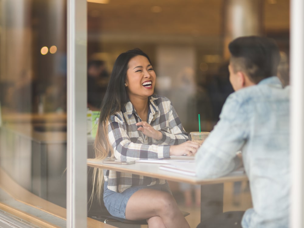 Residents laughing together at a local coffee shop near Terra Apartment Homes in Federal Way, Washington