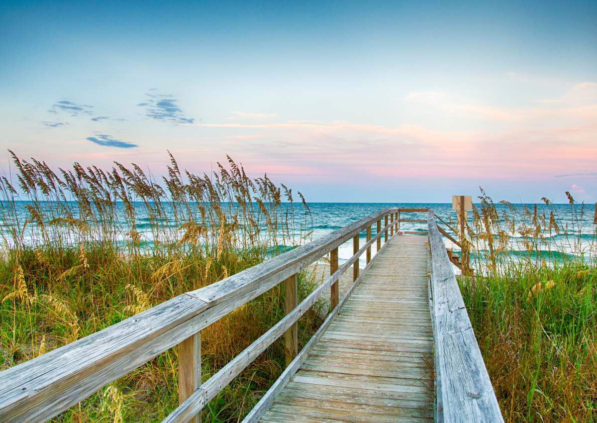Grass lined walkway leading to the beach near Proximity Carolina Beach in Carolina Beach, North Carolina