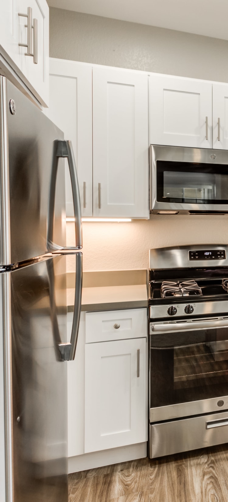 Modern kitchen with sleek, stainless-steel appliances in a model home at Sofi Westview in San Diego, California