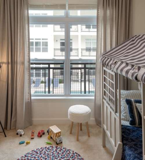 Bedroom for a kid with a large window at The Heron Downtown in Baton Rouge, Louisiana