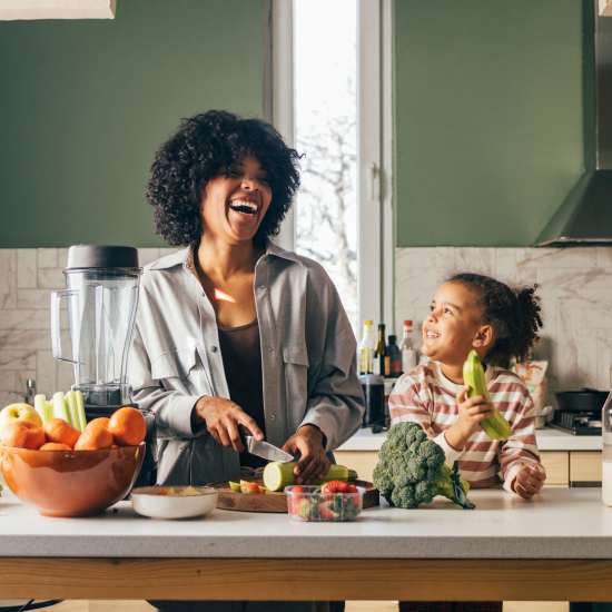 Bed and nightstand in a model home's bedroom at Viva at New Smyrna Beach in New Smyrna Beach, Florida