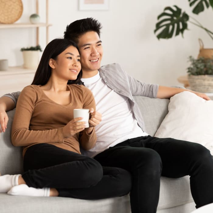 Residents relax on their sofa at Elevations One, Woodbridge, Virginia