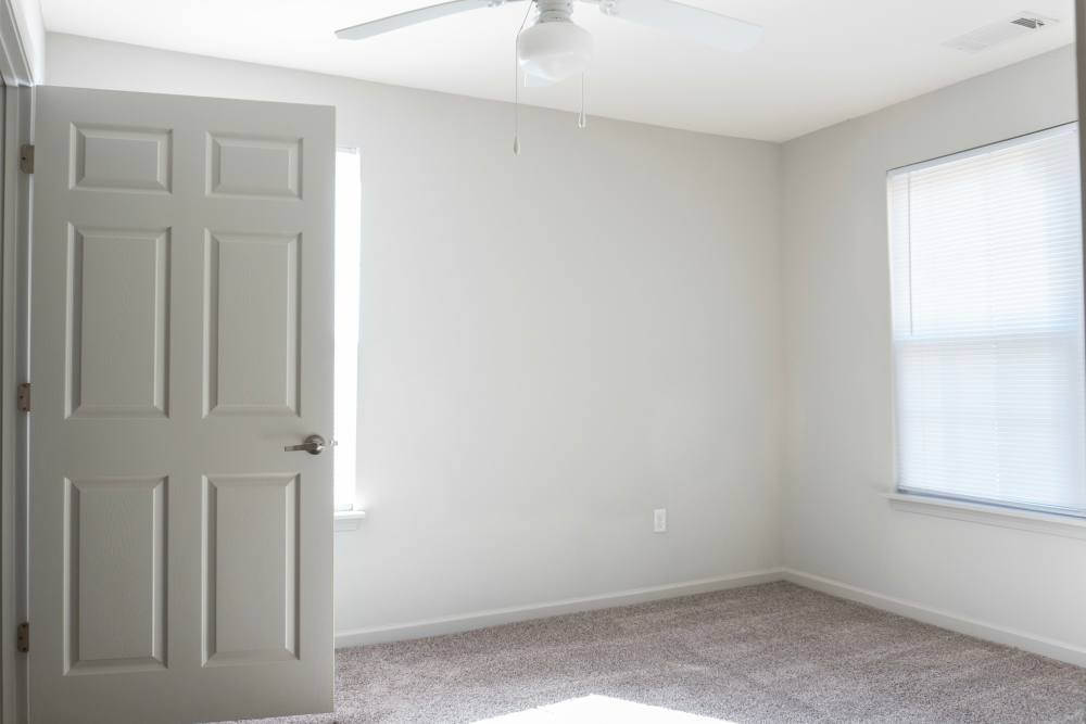 Well-lit apartment bedroom at Redland Creek in Lawrenceville, Georgia