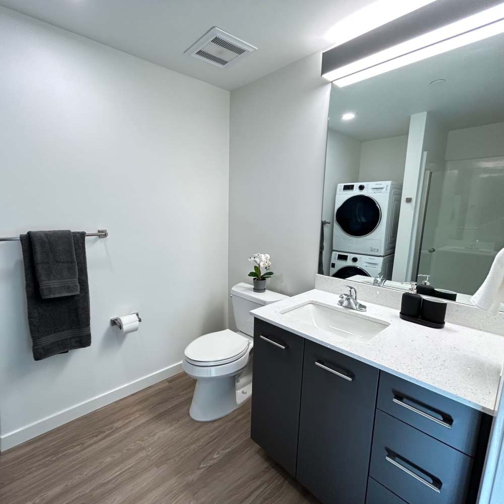 Bright bathroom with connecting washer and dryer area at DOCK 59 in Portland, Oregon