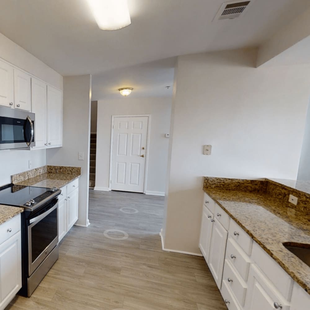 Kitchen with wood-style flooring at The Eva in Sandy Springs, Georgia