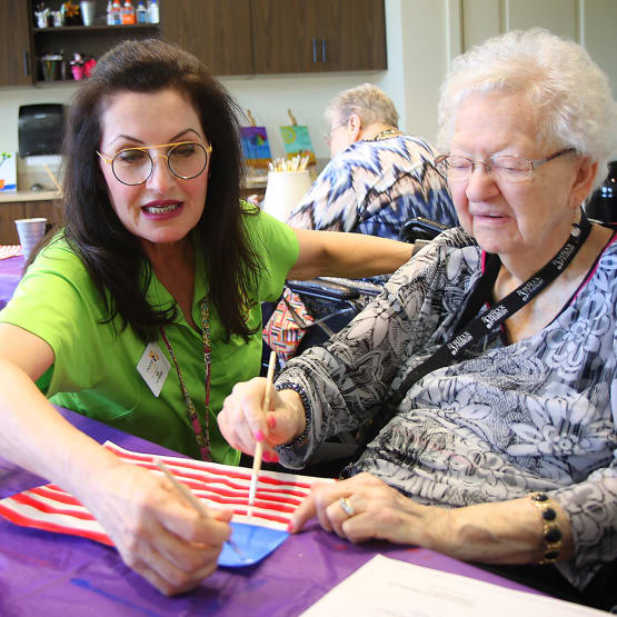 Resident painting with our Activities director at Prairie House Assisted Living and Memory Care in Broken Arrow, Oklahoma
