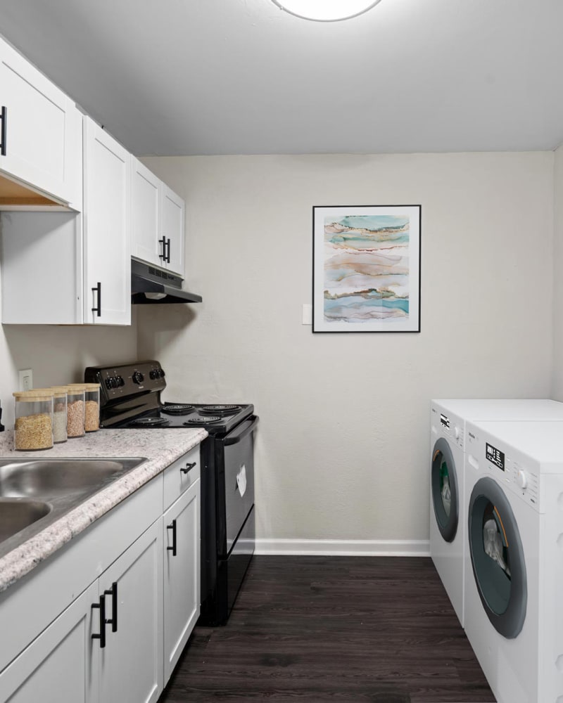 An apartment kitchen and laundry area at Spring Creek Apartment Homes in Decatur, Georgia