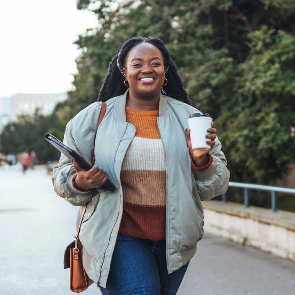 Woman holding her coffee cup at The Current Apartments in Biloxi, Mississippi