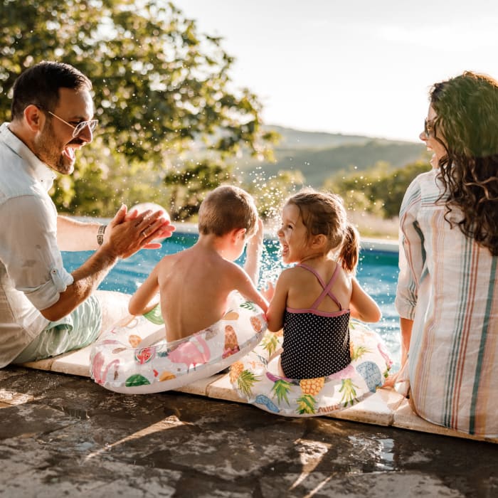 A family sits poolside at Promenade Pointe, Norfolk, Virginia