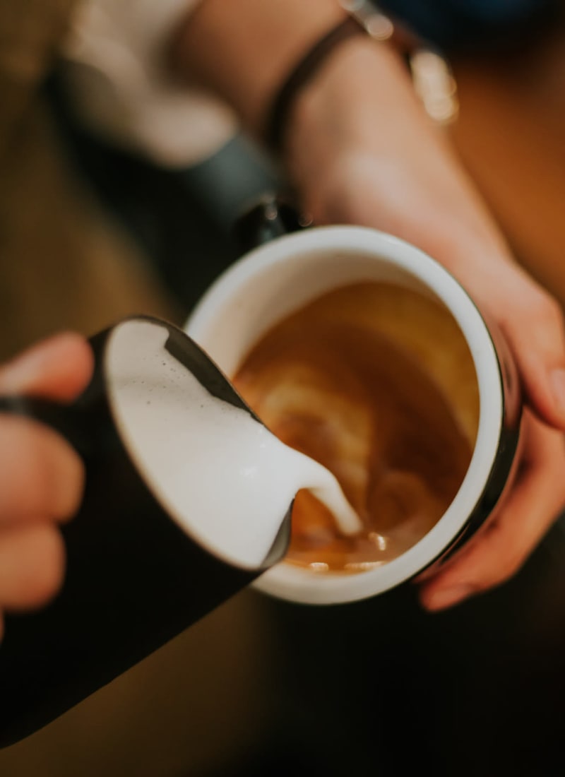 Barista preparing a latte near Marquis at Kingwood in Kingwood, Texas