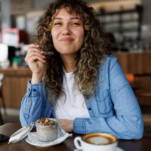 Resident having coffee at a cafe near Avonlea Riverside in Atlanta, Georgia