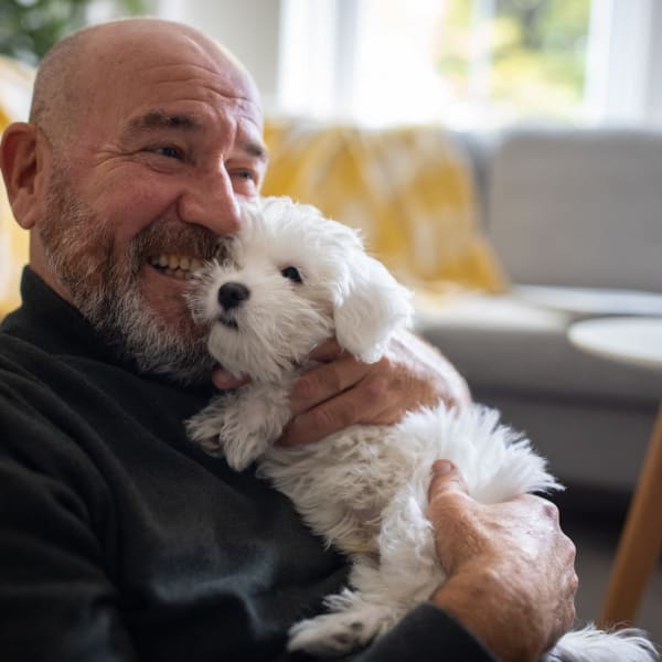 A resident holds his puppy at Promenade Pointe, Norfolk, Virginia