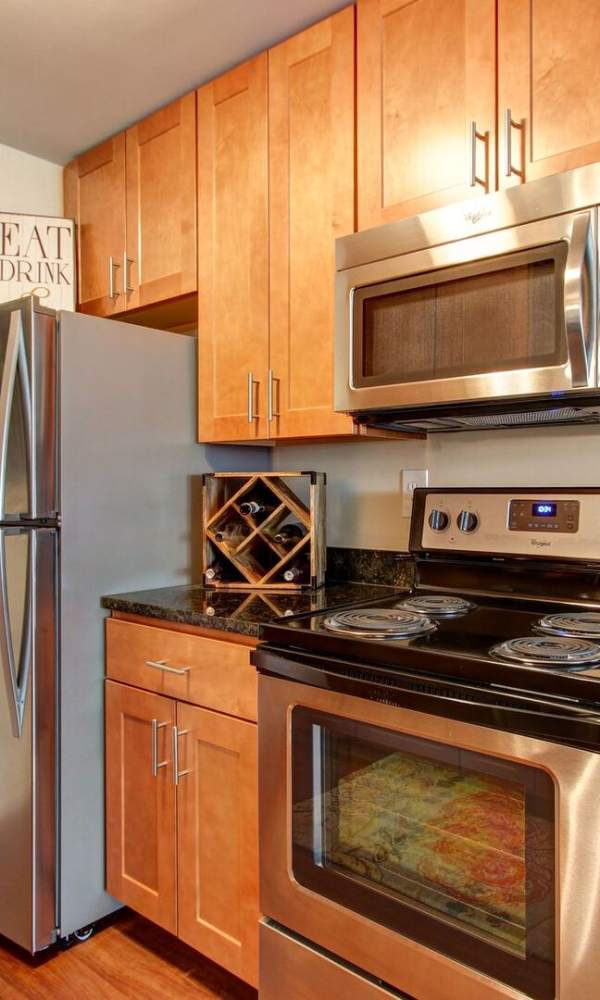 Kitchen with black appliances at The Elms at Centreville in Centreville, Virginia