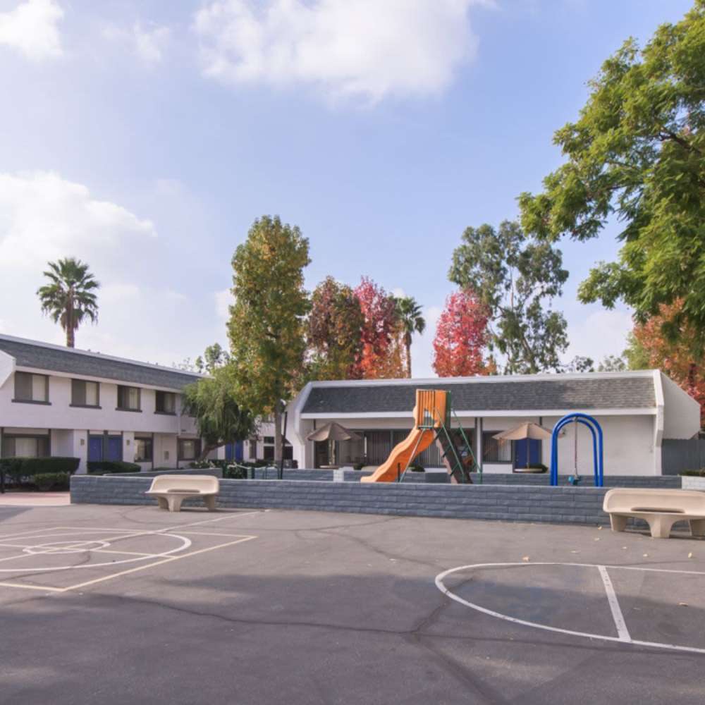 View of community with playground at Fairvalley Villa in Covina, California  