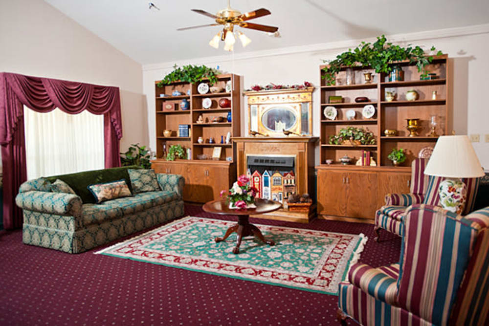 Sitting area with fan and armchairs at Cambridge Square Assisted Living in Rosenberg, Texas