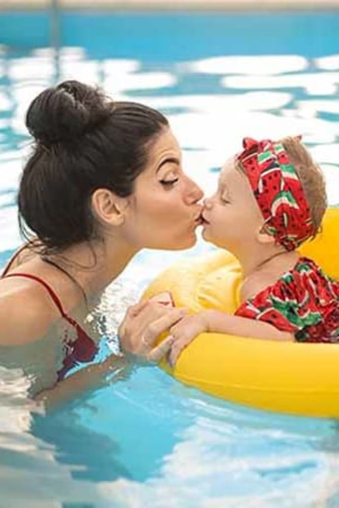 Mother and child in the pool at Glenbrook Apartments in Chico, California