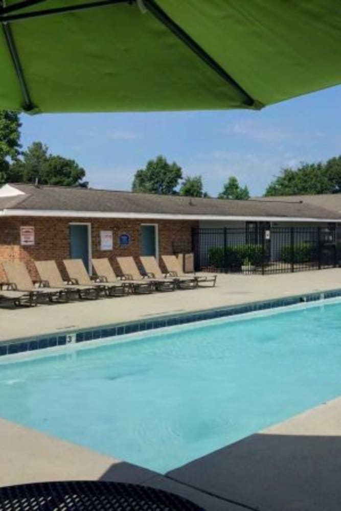 Umbrella covered table by the pool at Valley Terrace in Durham, North Carolina