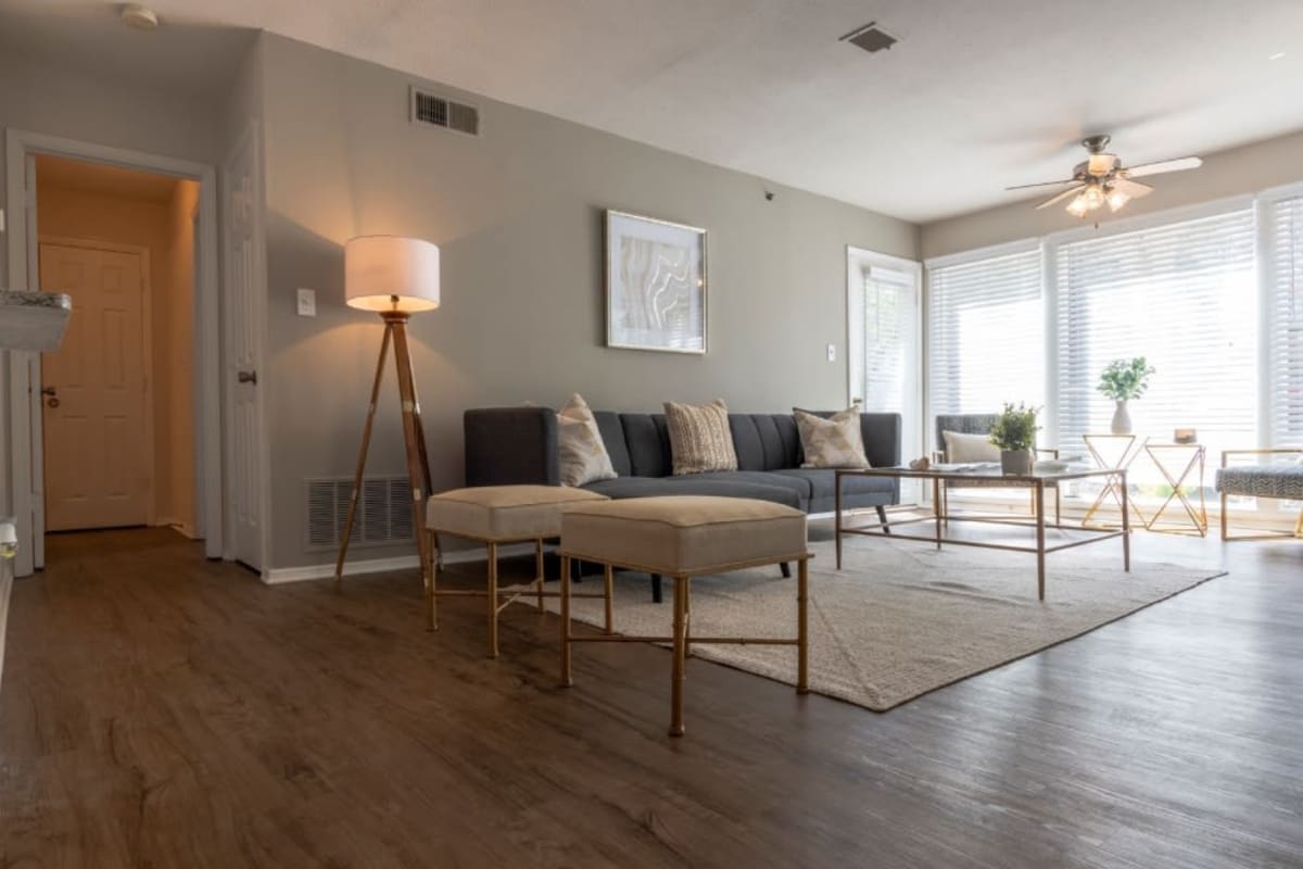 Apartment living room with wood-style flooring at Webb Bridge Crossing in Alpharetta, Georgia