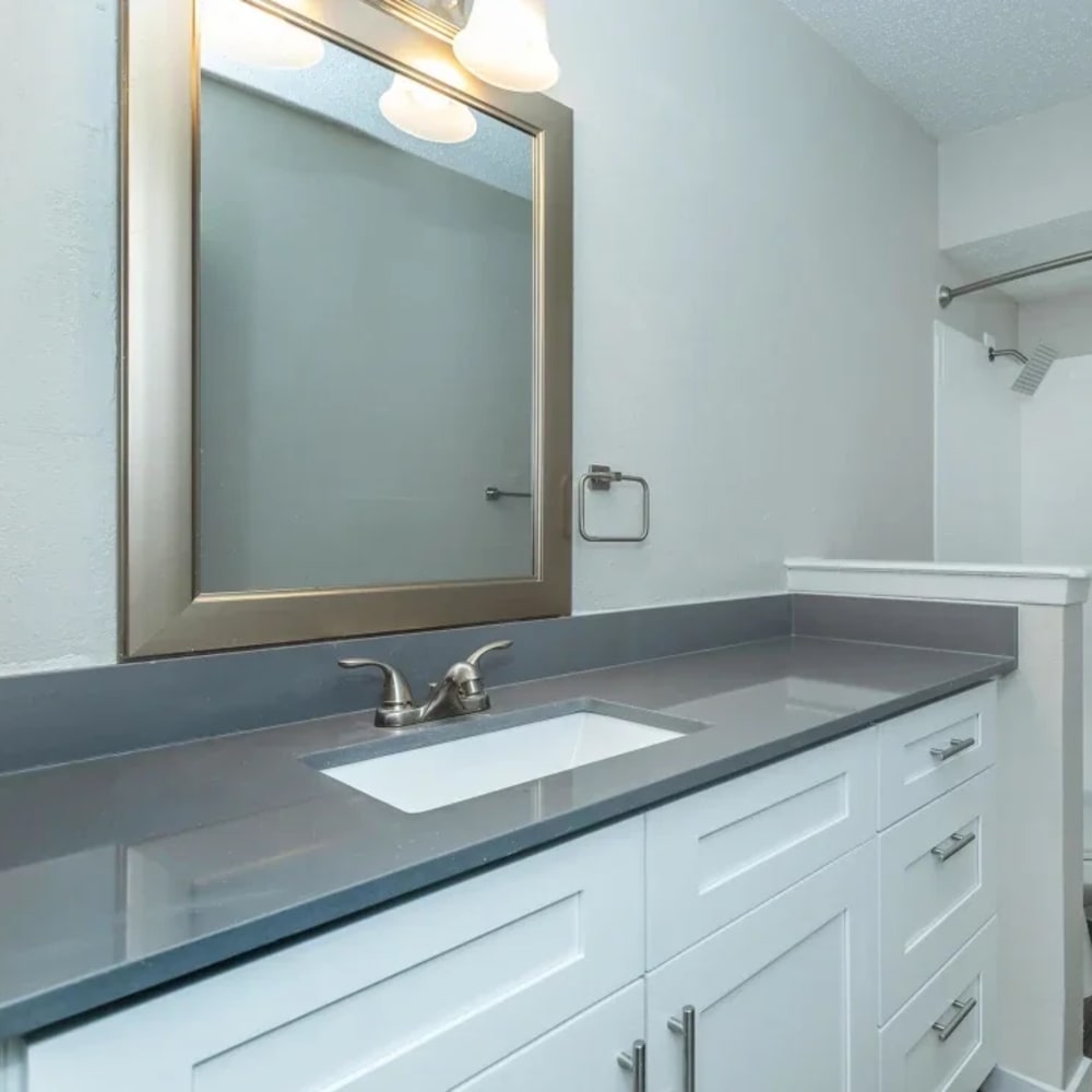 Woman looking at a tablet at Admiral Apartments in Fort Worth, Texas