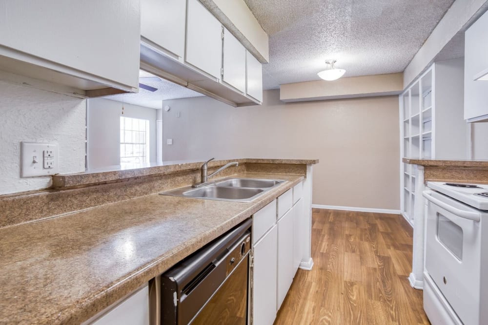 An apartment kitchen with a dishwasher at Santa Fe Apartment Homes in Dallas, Texas