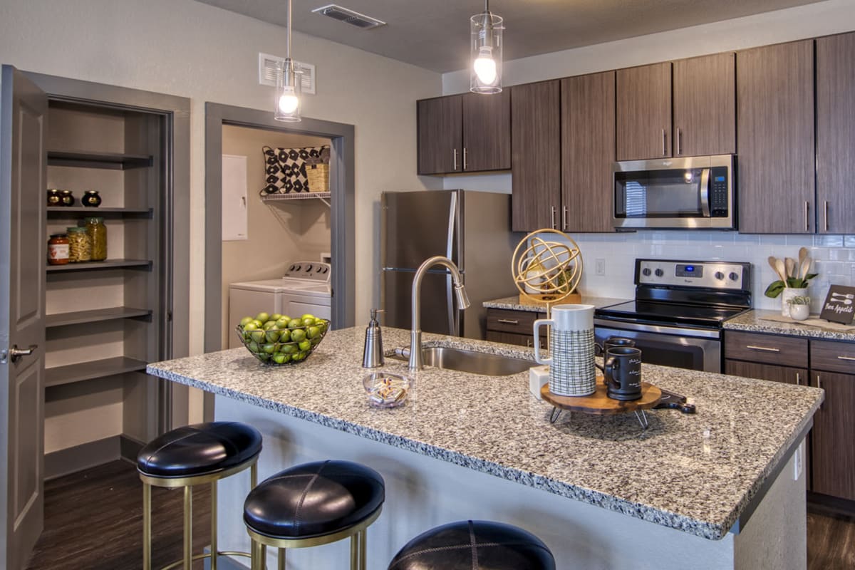 Apartment kitchen with an island at Lotus at Starkey Ranch in Odessa, Florida
