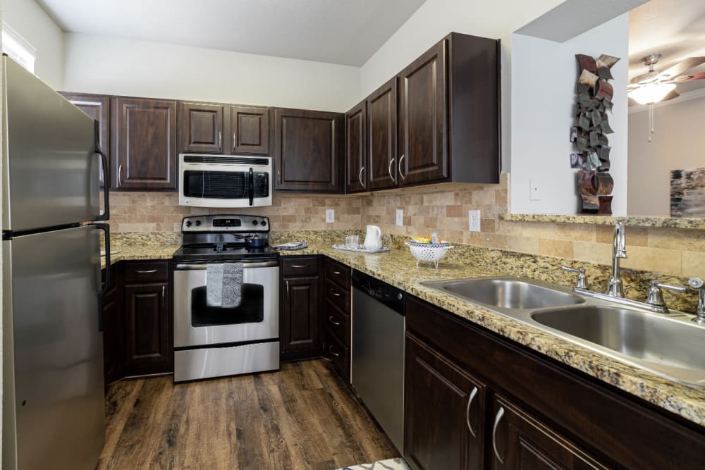 Modern style kitchen with granite counters at Marquis at Bellaire Ranch in Fort Worth, Texas