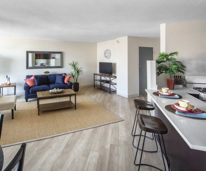 Living room with a view of open plan kitchen with bar stools at Skyview Downtown in Springfield, Massachusetts