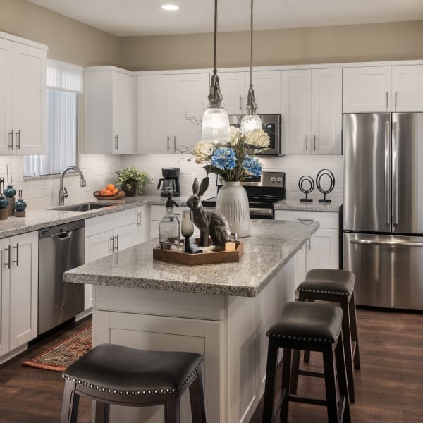 Modern kitchen with stainless-steel appliances in model home at San Villante in Mesa, Arizona