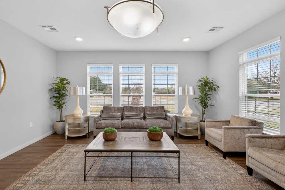 Charming living room featuring abundant natural light, stylish furnishings, and cozy accents at Lakewood Crossing in Granbury, Texas