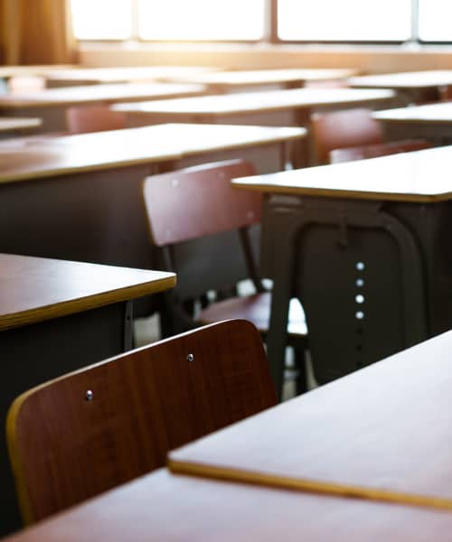 Wooden desks in empty classroom at St. Clairsville Courtyard in St. Clairsville, Ohio