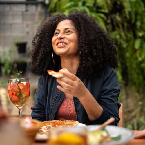 Resident having snacks at restaurant near Windsor Gardens Apartments in Rochester, New York