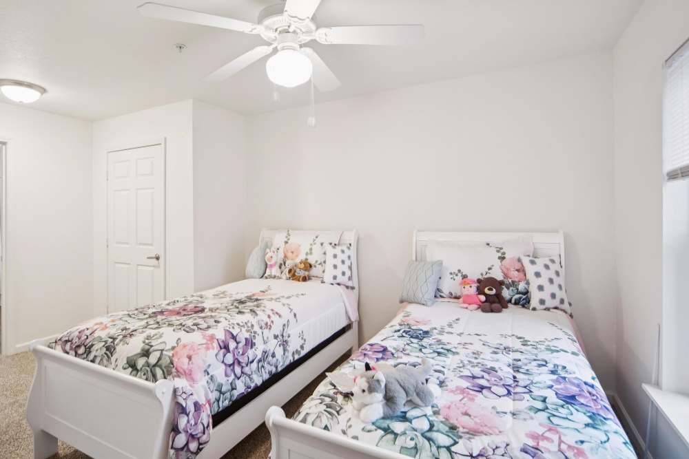 Bright, cozy bedroom with two twin beds and playful decor at Villas At Meadow Springs in Ankeny, Iowa