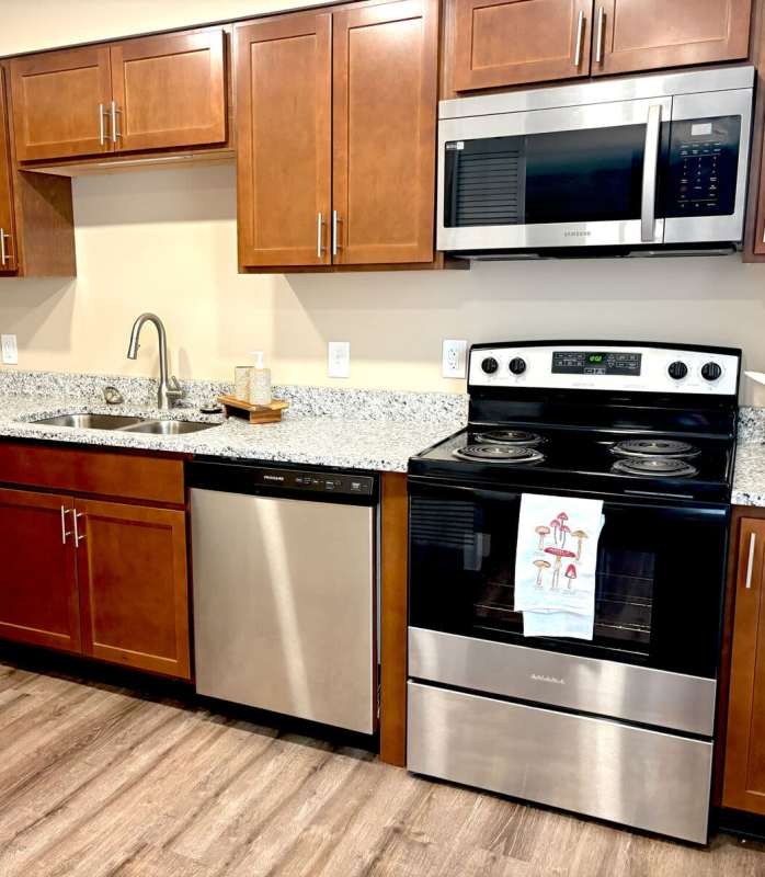 Modern kitchen with steel appliances at Charleston Square Apartments in Columbus, Indiana