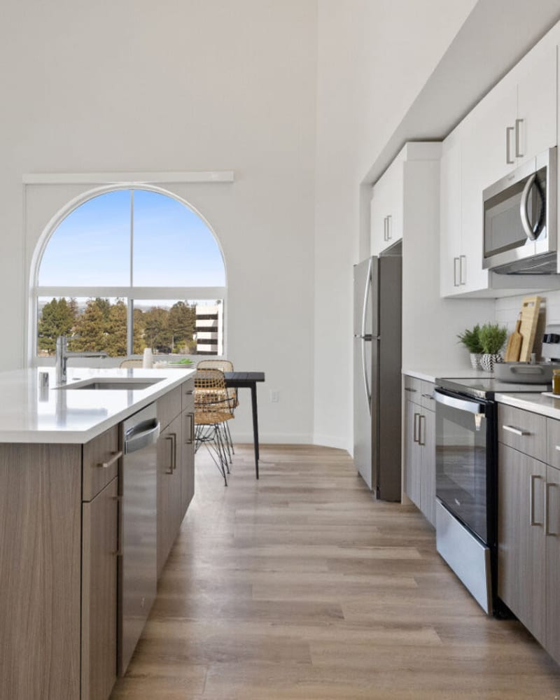 Arched windows and stainless-steel appliances in an apartment at Lincoln Landing in Hayward, California