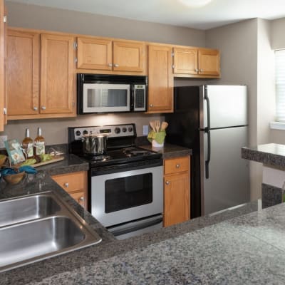Modern kitchen with stainless-steel appliances in a model home at Timbers at Tualatin in Tualatin, Oregon