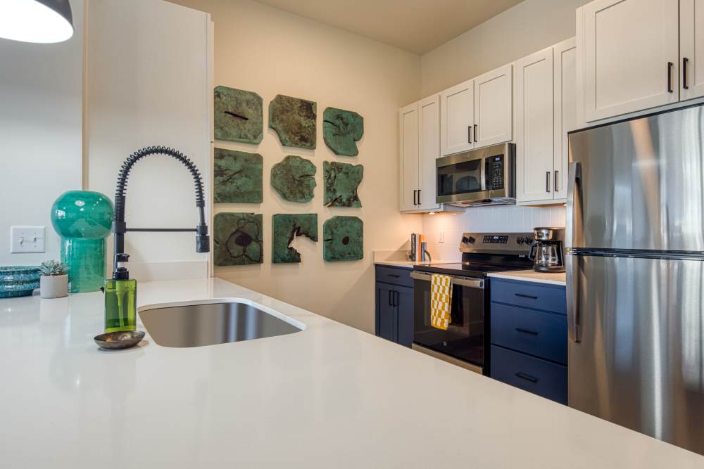 Modern kitchen with quartz countertops and appliances at Fusion at Neon in Norfolk, Virginia