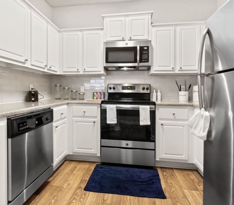 Modern kitchen with white cabinets at Marquis Midtown West in Atlanta, Georgia
