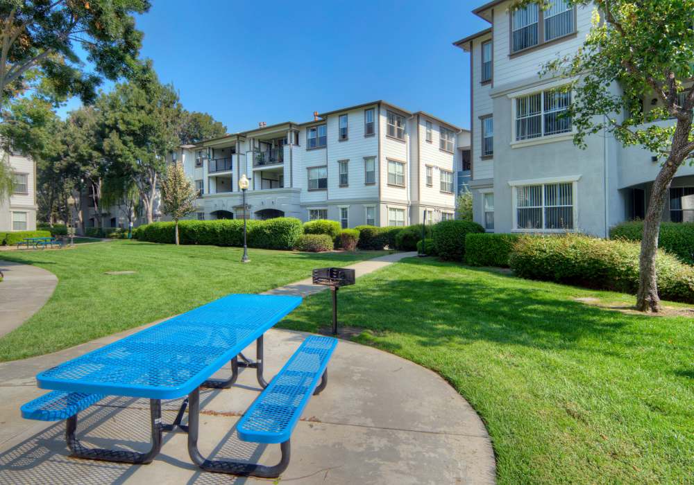 Seating area in front of n apartment at Park Hacienda Apartments in Pleasanton, California