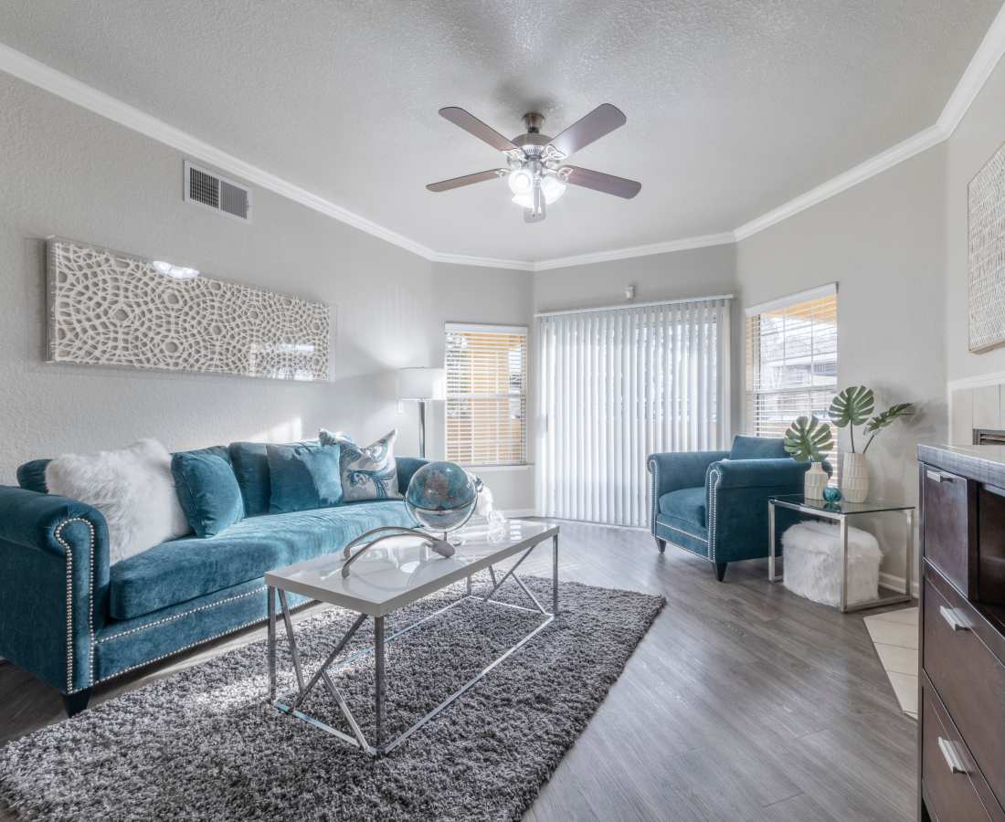 Living room with access to balcony at Oak Brook Apartments in Rancho Cordova, California