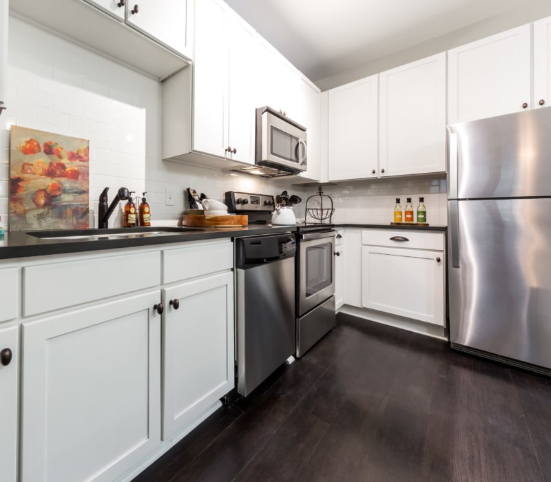 Modern style kitchen with white cabinets and stainless steel appliances at Marquis at Buckhead in Atlanta, Georgia