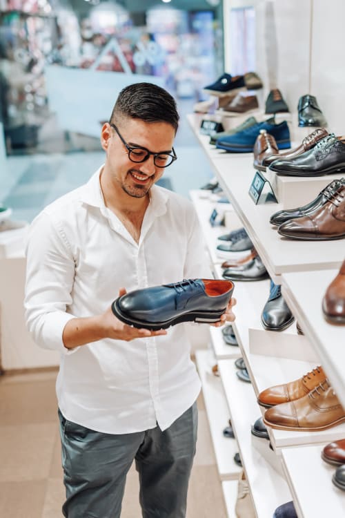 Resident browsing shoes near Parallel 36 at Legacy in Opelika, Alabama