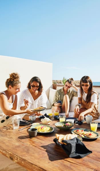 Friends enjoy a meal in the sun at University Lofts at Greensborough Village, Jonesboro, Arkansas