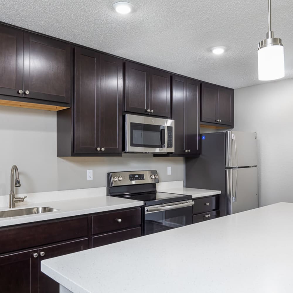 Kitchen with new counters and modern appliances at Springhill Apartments in Overland Park, Kansas