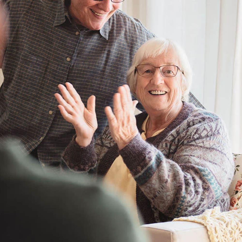 Happy resident clapping her hands at Anthology of Mayfield Heights in Mayfield Heights, Ohio