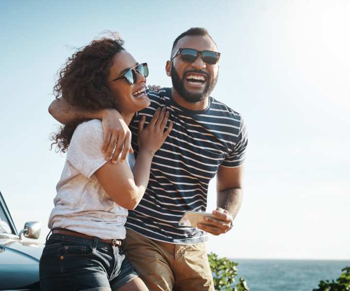 Couples enjoying and taking selfie beachside near El Cid Apartments in West Palm Beach, Florida
