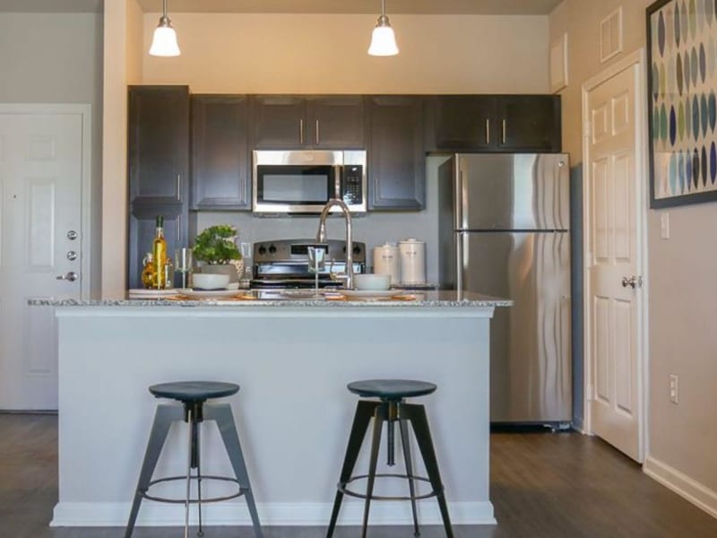 Model home kitchen and entrance at Biltmore at the Park in Pflugerville, Texas