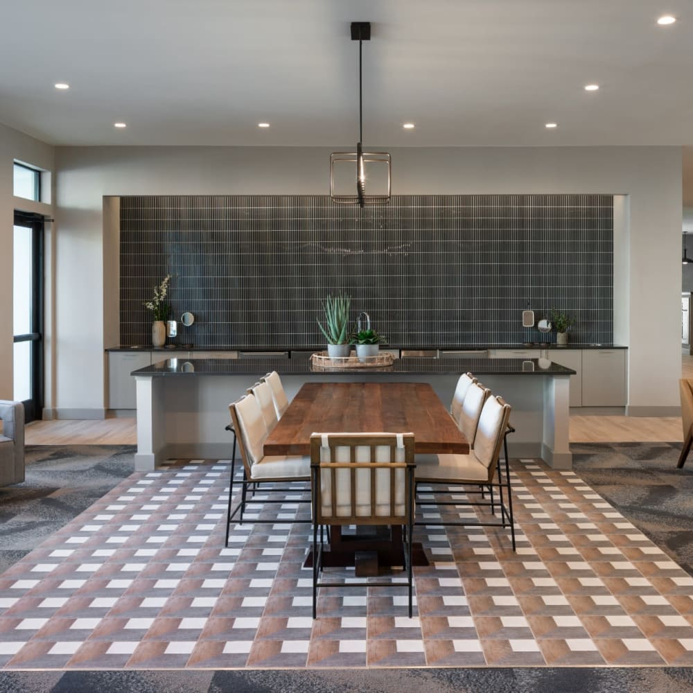 Resident lounge with large wooden dining table and area rug at Bellrock La Frontera in Austin, Texas